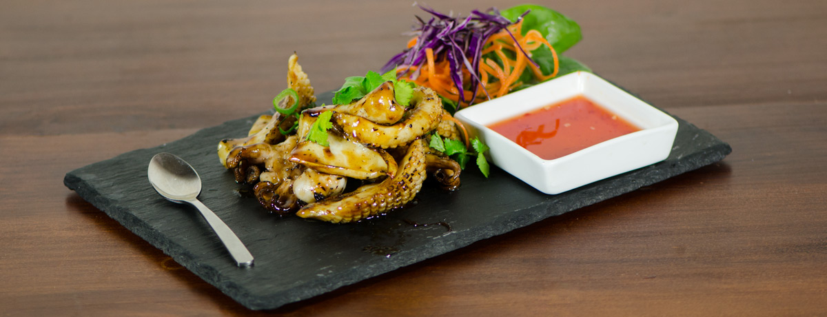 Thai style marinated baby octopus or calamari barbecued and served with Thai spicy sauce